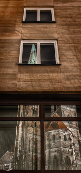 Türme der Sebalduskirche spiegeln sich in Fenstern